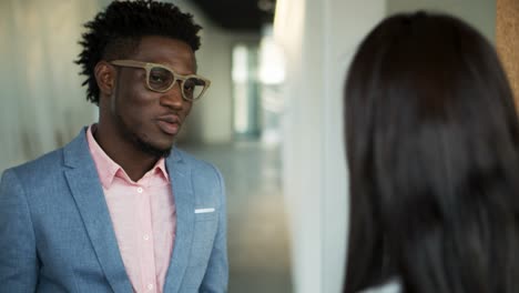 Thoughtful-African-American-man-talking-with-colleague